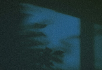 Moody abstract image featuring grainy dark blue tones with a soft, shadowy silhouette and subtle glow, creating a cinematic atmosphere ideal for creative projects and mood visuals.