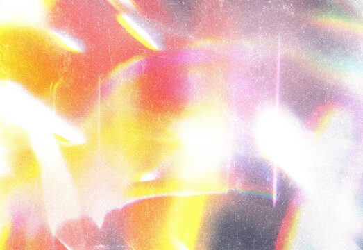 Abstract vibrant light texture featuring warm orange pink and yellow glow with soft bokeh and lens flare effects creating a colorful background for design projects