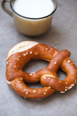 Delicious traditional Bavarian Brezeln or pretzels with a brown salty crust. German Pretzel Brezel with cup of milk. Food on Oktoberfest