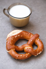 Delicious traditional Bavarian Brezeln or pretzels with a brown salty crust. German Pretzel Brezel with cup of milk. Food on Oktoberfest