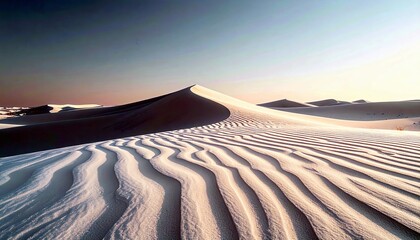 Vast desert landscape with undulating sand dunes sculpted by the wind, featuring intricate ripple patterns on the foreground sand under a clear, gradient sky.