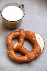 Delicious traditional Bavarian Brezeln or pretzels with a brown salty crust. German Pretzel Brezel with cup of milk. Food on Oktoberfest