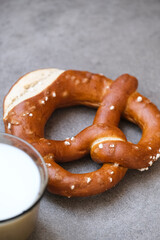 Delicious traditional Bavarian Brezeln or pretzels with a brown salty crust. German Pretzel Brezel with cup of milk. Food on Oktoberfest