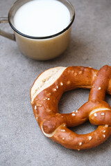 Delicious traditional Bavarian Brezeln or pretzels with a brown salty crust. German Pretzel Brezel with cup of milk. Food on Oktoberfest