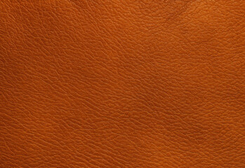Fototapeta premium Extreme close up of rich orange brown leather texture with natural grain and subtle sheen, showcasing tactile depth for luxury fashion, upholstery, and packaging design projects