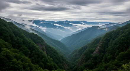 Misty mountain valley with dramatic clouds