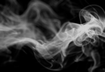Abstract monochrome smoke background with flowing wisps and soft curves creating a dramatic moody atmosphere, ideal as a versatile design backdrop for photography and digital art