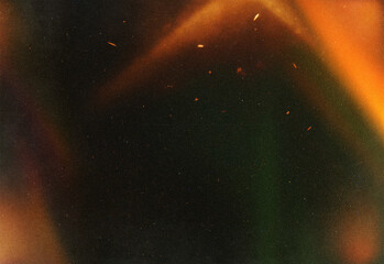 Abstract dark background with warm orange light leaks, subtle film grain, and scattered sparks, creating a texture ideal for design assets, photography, and video projects