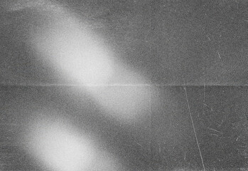 Abstract black and white noise texture featuring soft diagonal light streak and film grain, ideal as a versatile background, overlay, or design element in creative projects