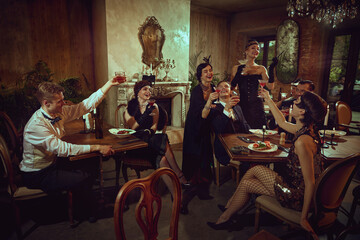 Elegant dinner party toast with friends in vintage evening wear. Concept of holiday promo, New Year event visuals, retro-evening invitations, premium alcohol campaigns, luxury nightlife ads.