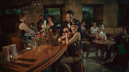 Laughing guests in vintage fashion enjoying cocktails and social moments at the bar. Concept of bar promo, nightlife content, luxury alcohol campaigns, event marketing, and social lifestyle visuals.