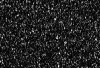 Fototapeta premium Close up of fine white specks scattered across a deep black background, creating a granular texture suitable for winter scenes, star field effects, and abstract design projects
