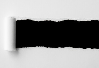 Minimalist studio shot of a wide torn black stripe across a white textured background, with a rolled edge on the left creating strong negative space and high-contrast design appeal