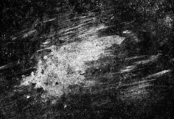 Close up of an abstract black and white textured surface with scattered dust, grainy speckles and broad brushstroke marks creating a high contrast artistic background for design