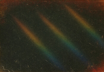 Abstract image with rainbow light streaks across a dark textured background, ideal for design projects, digital art, backdrops, texture overlays, and creative presentations