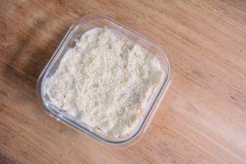 Creamy White Dip in Glass Dish on Wooden Table.