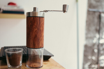 Manual Coffee Grinder with Wooden Body and Glass Jar.