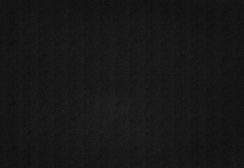 Close up of a dark black textured surface with a fine speckle pattern and subtle grain, ideal as a versatile background for design, photography, marketing, and creative projects