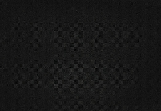 Close up of a dark black textured surface with a fine speckle pattern and subtle grain, ideal as a versatile background for design, photography, marketing, and creative projects