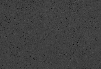 Dark rough concrete texture background featuring subtle speckled grain and a soft vignette, ideal for industrial design, product presentations, website backdrops, and print layouts
