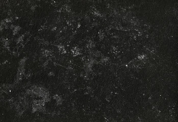 Close up texture of a deep black stone surface with subtle white mineral flecks and a rough granular pattern, ideal for backgrounds, design accents, and product photography