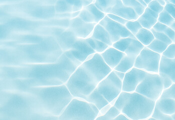 Close-up of sunlit pool water with shimmering reflections and rippling patterns in cool blue tones, conveying a tranquil, refreshing mood for travel, lifestyle, spa, and outdoor scene visuals