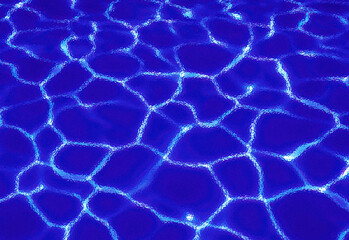 Obraz premium Close up of sunlight dancing on a clear blue pool surface, creating bright, interconnected shimmering patterns of water reflections on rippling water, ideal for summer advertising.