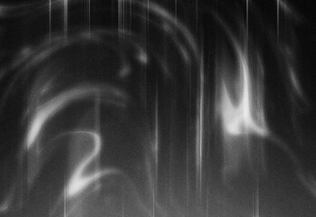 Monochrome abstract background with grainy texture, soft light trails and flowing wisps across a dark celestial-inspired scene, ideal for creative design, overlays and layouts