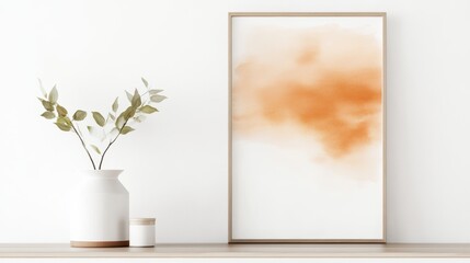 A minimalist decor featuring a watercolor artwork in a wooden frame, alongside a simple vase with greenery, creating a serene atmosphere.