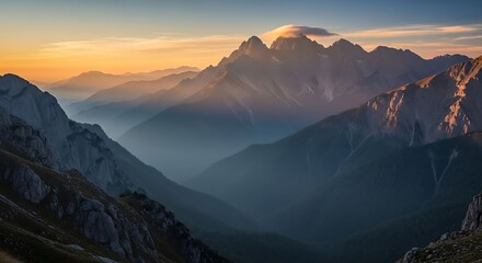 Stunning mountain peaks bathed in golden sunrise light, creating a breathtaking vista of layered valleys and misty atmosphere.