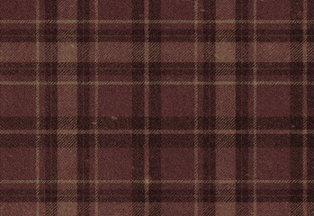 Close up of burgundy plaid wool fabric with subtle yellow and brown threads, cozy warm textile texture ideal for fashion apparel, blankets, crafts and interior design projects