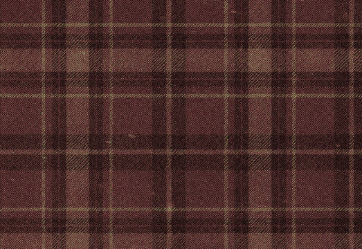 Close up of burgundy plaid wool fabric with subtle yellow and brown threads, cozy warm textile texture ideal for fashion apparel, blankets, crafts and interior design projects
