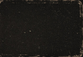 Macro shot of a rugged dark surface with subtle grain and worn edges, presenting a versatile texture that resembles leather, asphalt, or vintage film for creative design use