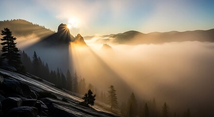Sunrise over the misty mountain range with sun rays.
