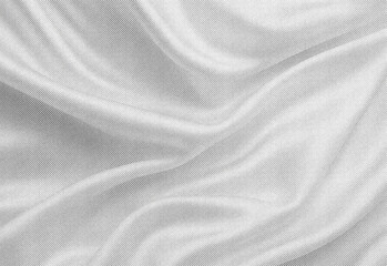 Fototapeta premium Close up of soft gray fabric with flowing folds and smooth woven texture, creating a versatile background for design, textile presentations, product photography, and layouts