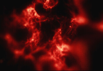 Abstract red plasma nebula texture featuring fiery filaments, luminous gas clouds and dark voids for sci fi design, space background, dramatic cosmic ambiance and depth
