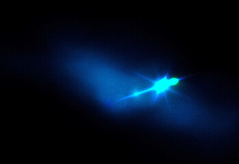 Abstract neon blue light trail moving through dark space, sparkling particles disperse around a bright central beam, evoking cosmic energy, motion, and technological futurism