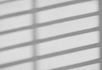 Abstract grayscale pattern of window blinds casting parallel shadows across a flat surface, creating a minimalist modern interior ambience for design and photography projects