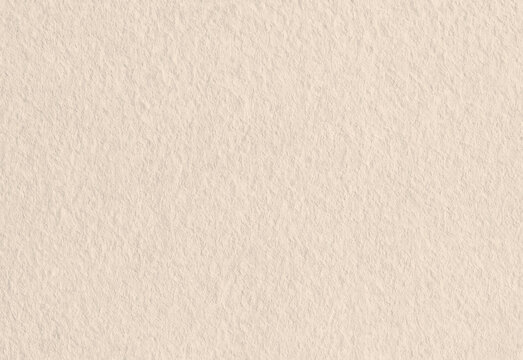 Close up of a warm beige textured paper background showing subtle fibers, soft natural color variations, and a gentle patterned surface suitable for invitations and backgrounds