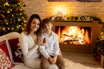 Happy family on Christmas, enjoying some quality time together, kids and adults with pet dog on Christmas eve in decorated home