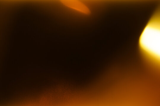 light leak overlay effect with scratch dust and orange blur light leaks,retro grain noisy film flare on black background,analog old film burn overlay,abstract background with red rays and lens