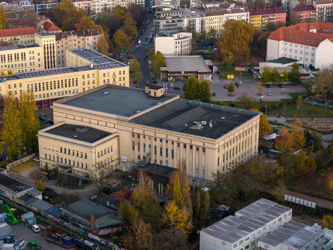 Aerial view of the iconic Berghain nightclub amidst the urban landscape, with its stark facade contrasting against the autumnal hues of Berlin, Berlin, Germany.