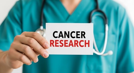 Closeup of a doctor holding a card with the words cancer research