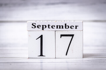 A wooden calendar block displays the date September 17. This minimalist design adds a touch of elegance to home decor, marking special occasions or reminders.