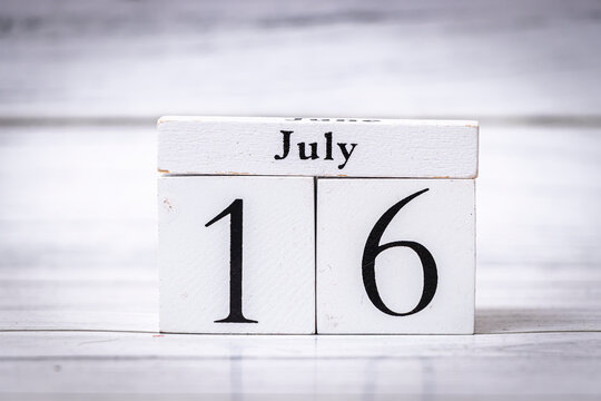 A calendar block displaying the date July 16, resting on a wooden surface. This simple yet elegant design is ideal for planning, reminders, and decor.