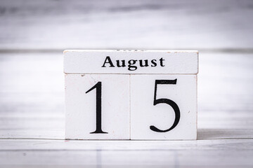 Wooden calendar cubes displaying the date August 15. This image represents time management and...