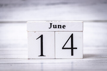 White calendar blocks displaying the date June 14, symbolizing summer and time management. Ideal for lifestyle and planning themes.