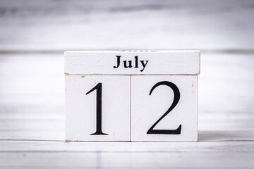 Wooden calendar blocks displaying July 12, symbolizing dates, organization, and planning. Ideal for scheduling, reminders and seasonal content representation.