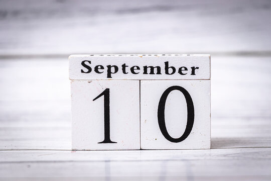 A wooden calendar block displaying the date September 10, suggesting time and planning, commonly used for scheduling events or reminders. Minimalist design.
