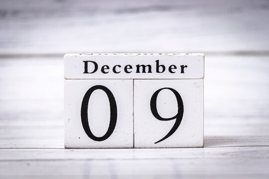 White wooden calendar displaying December 09 highlights the significance of dates and events. Suitable for themes of time management, holidays, and seasonal planning.
